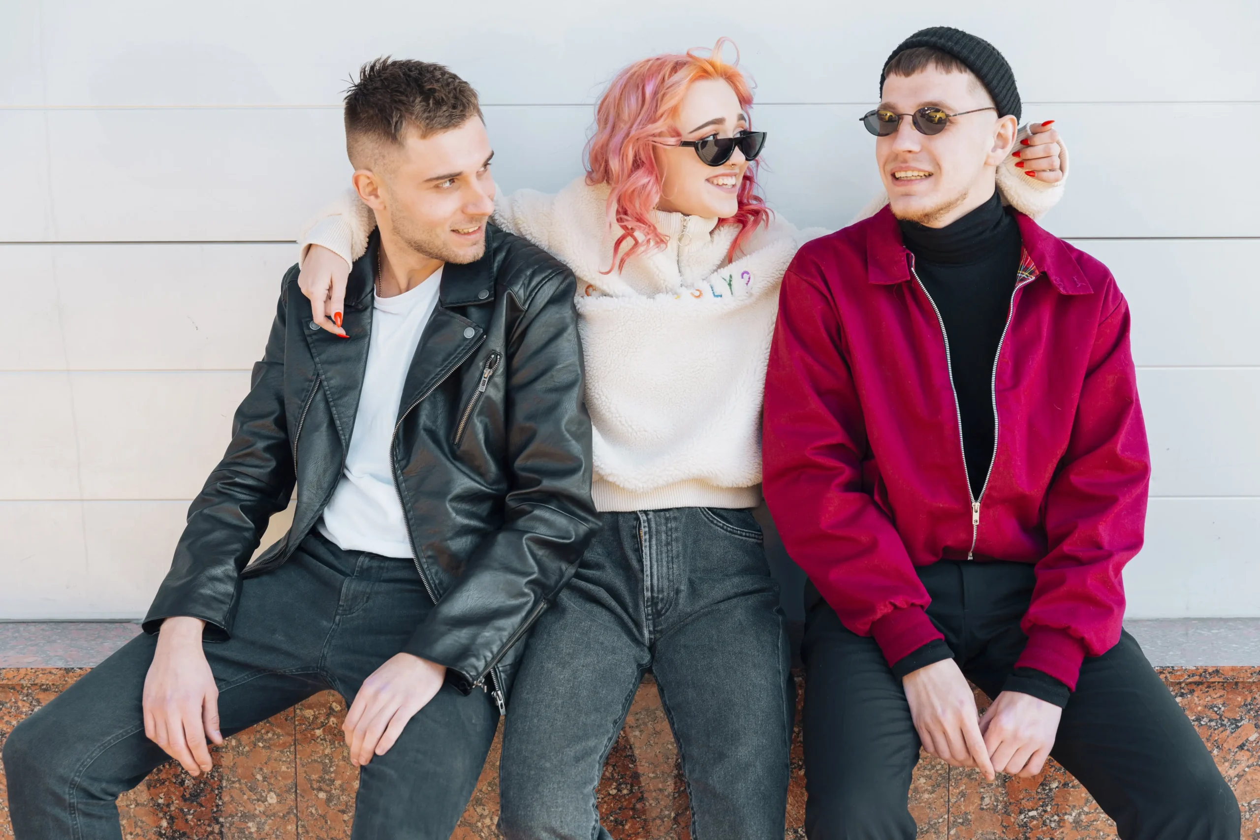 young-friends-sitting-bench-looking-man-min